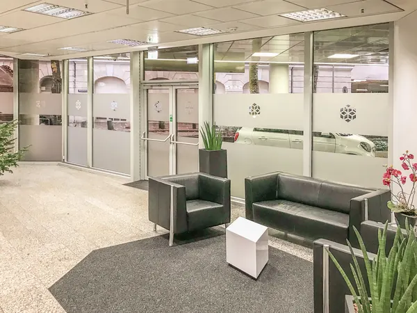 Glasddekorfolie als Streifen geschnitten mit ausgeschnittenem Logo. Beklebung eines Büro Empfangs einer Hamburger Bank.